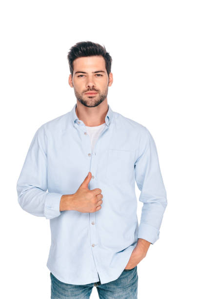 istock handsome young man showing thumb up and looking at camera isolated on white 1048257692