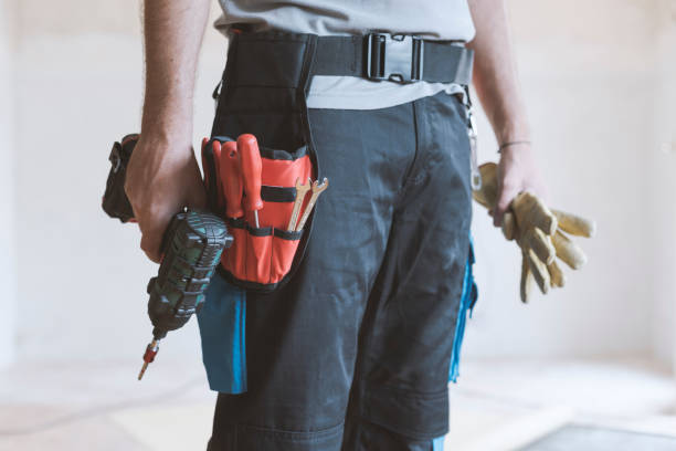 istock Professional repairman standing and holding a drill 1048259008