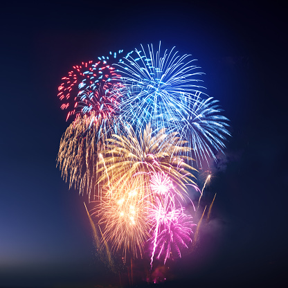 A large colourful firework display background.