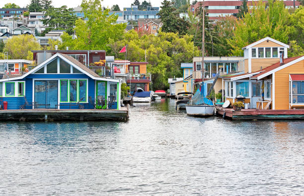 Lake Union, Seattle, Washington State, USA. Boats, houseboats, cabin cruisers, yachts and marine water craft of all shapes and sizes are moored alongside piers and pontoons at the waterfront, Lake Union, Seattle, Washington State, USA, including this floating avenue of holiday home houseboats with their boats