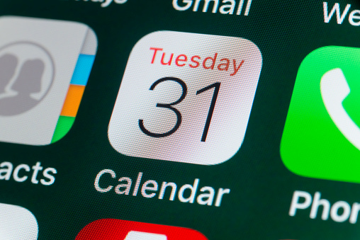 London, UK - July 31, 2018: The buttons of the Apple app Calendar, surrounded by Contacts, Phone, Gmail and other apps on the screen of an iPhone.