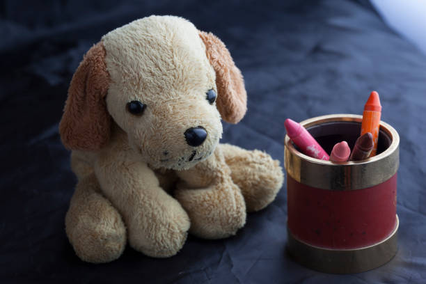 Brown soft toy lying among New Years gifts. Choosing gift for children concept