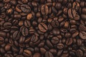 Roasted coffee beans. Background, close-up top view. Healthy breakfast.