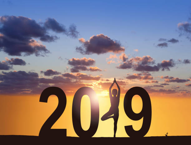 istock Yoga woman posing outdoors for happy new year 2019 1048281162