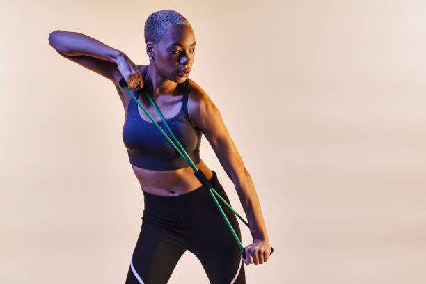 istock Woman stretching resistance band and looking to side 1048281294