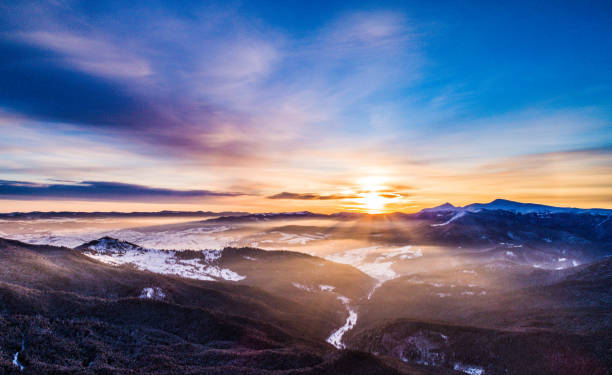 Winter higth in Carpatian mountains, beautiful dawn landscape with a bird's eye view, drone camera.