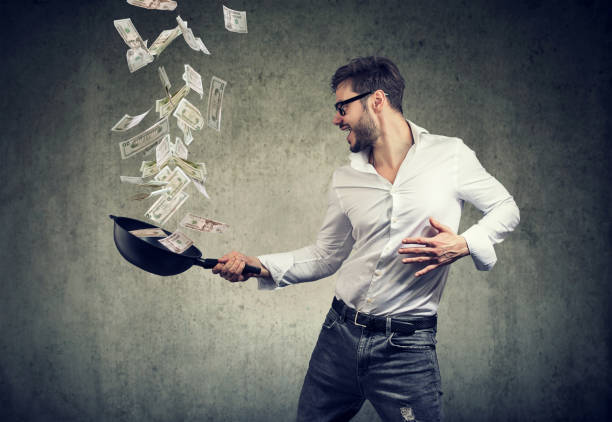 istock content man with frying pan full of dollar bills 1048288214