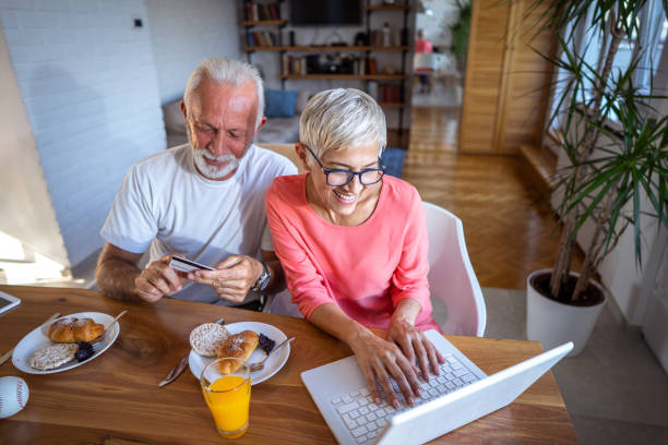 istock Senior couple enjoying online shopping 1048289372