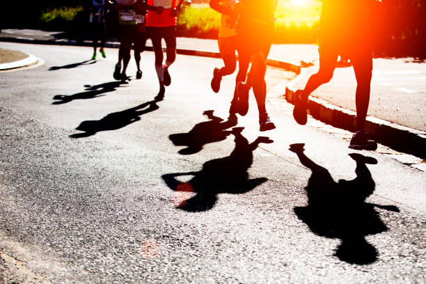 istock Shadows of runners on the road 1048290628