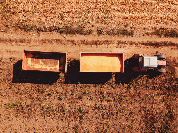 istock Aerial view of agricultural tractor with cargo carts 1048294740