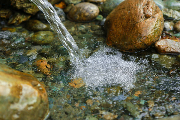 Waterfall, spring, river with stones outdoors stock photo
