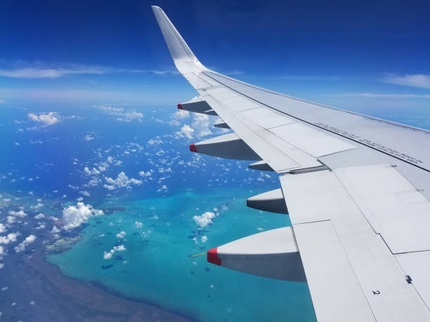 istock Airplane wing view above the Caribbean sea. 1048300702