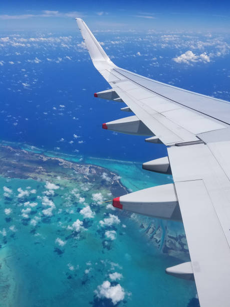istock Airplane wing view above the Caribbean sea. 1048300712