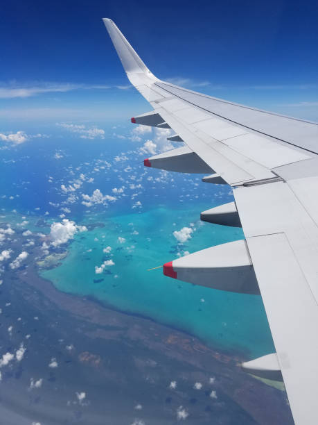istock Airplane wing view above the Caribbean sea. 1048300748