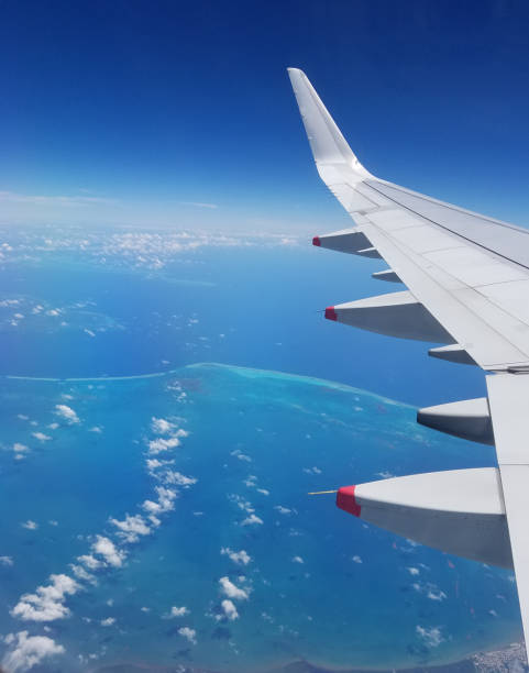 istock Airplane wing view above the Caribbean sea. 1048300792