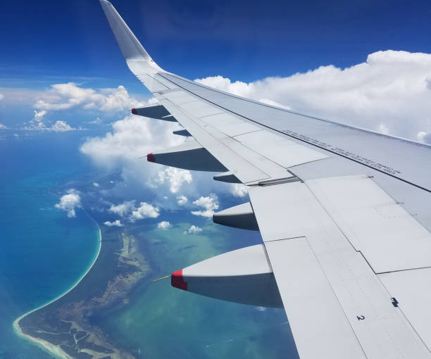 istock Airplane wing view above the Caribbean sea. 1048300814