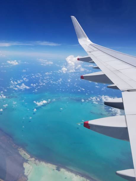 istock Airplane wing view above the Caribbean sea. 1048300862