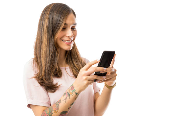 istock Smiling Female Blogger Text Messaging On Mobile Phone 1048301094