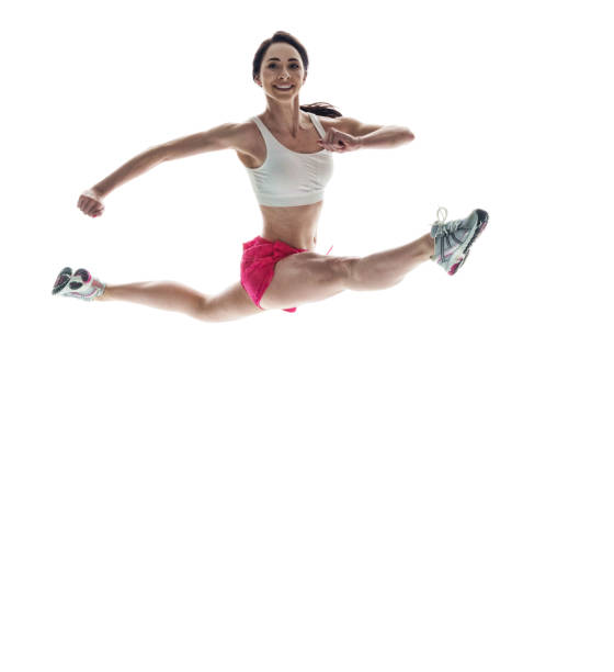 istock Beautiful athletic woman jumping with legs spread apart 1048301358