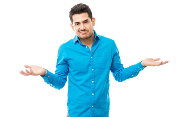 istock Unsure Man Wearing Blue Shirt While Shrugging His Shoulders 1048303416