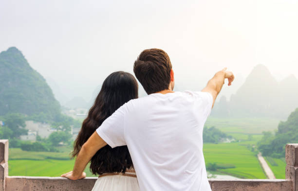 istock Couple enjoying Karst mountain view together 1048303826
