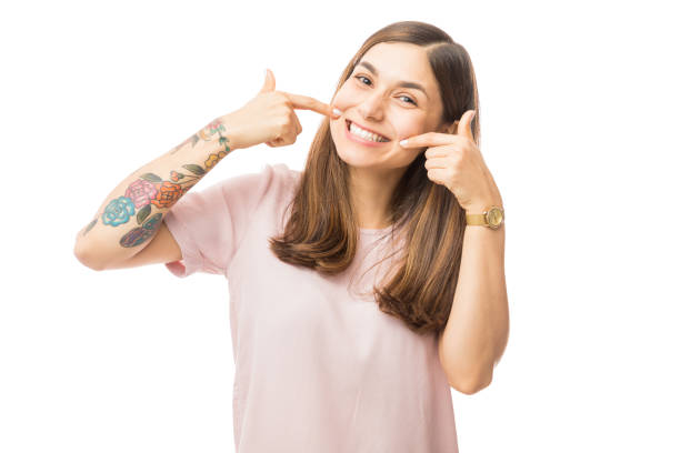 istock Woman Showing Her Perfect Straight White Teeth 1048305676