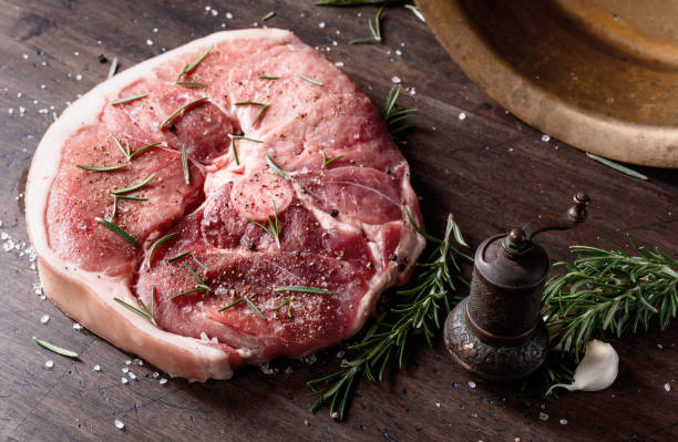 istock Raw pork with rosemary , salt and pepper. 1048306772