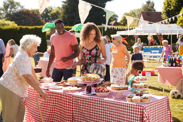 busy cake stall at summer garden fete - family child crowd british culture imagens e fotografias de stock