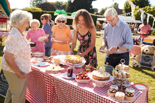 busy cake stall at summer garden fete - family child crowd british culture imagens e fotografias de stock