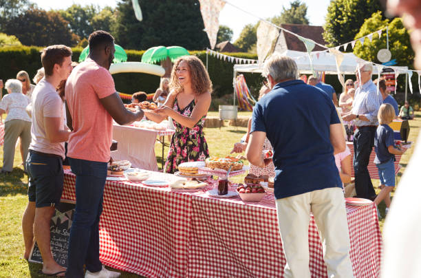 busy cake stall at summer garden fete - family child crowd british culture imagens e fotografias de stock