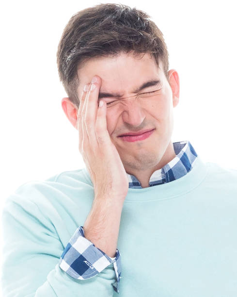istock Handsome young man sitting and feeling a headache 1048320774