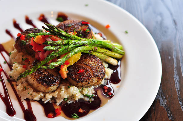 istock Fancy dinner of scallops and asparagus with other vegetables 104832150