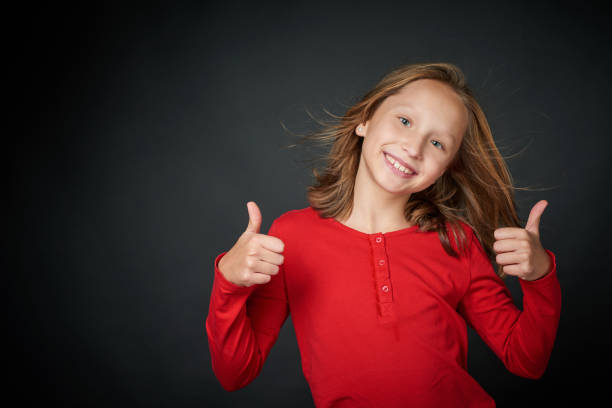 Happy girl gesturing thumbs up