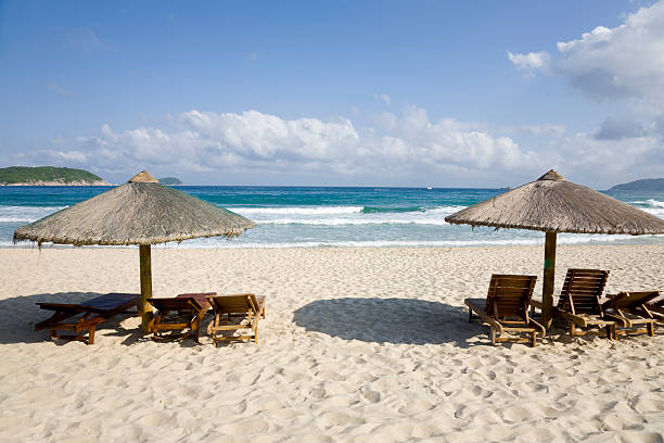 istock lounge chairs and umbrellas by the sea 104832476