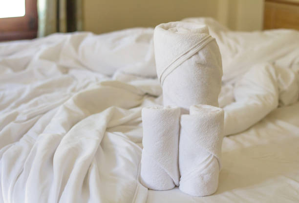 istock rolled up white beach towel in bedroom 1048326238