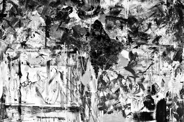 Abstract black and white photograph showing a rough, weathered surface with visible film grain and texture.