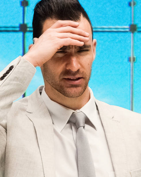 istock Handsome businessman standing at work and feeling worried 1048332150