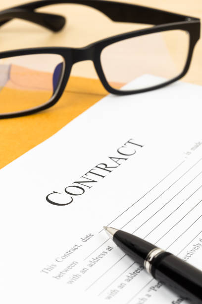 istock Business contract document with pen and glasses on envelope 1048332304