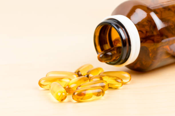 istock Fish oil capsule food supplement with bottle 1048332318