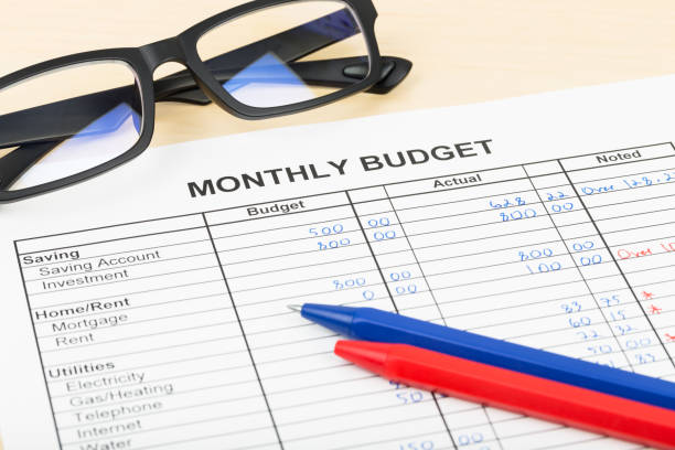 istock Home budget planning sheet with pen and glasses 1048332538