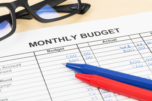 istock Home budget planning sheet with pen and glasses 1048332544