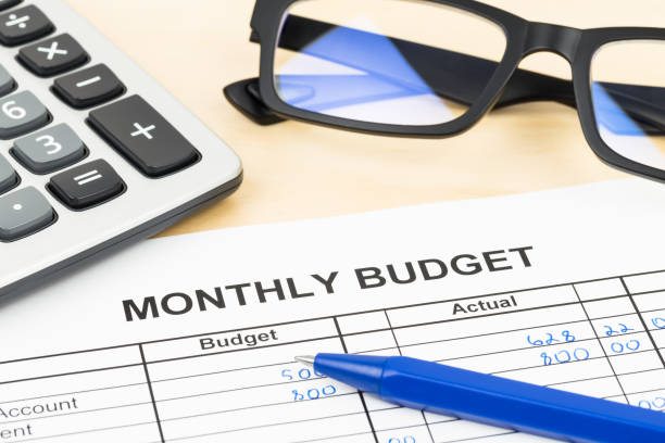 istock Home budget planning sheet with pen, glasses, and calculator 1048332552