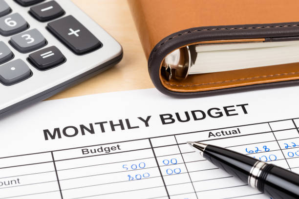 istock Home budget planning sheet with pen and calculator 1048332572