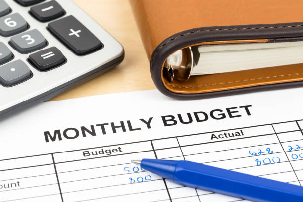 istock Home budget planning sheet with pen and calculator 1048332596
