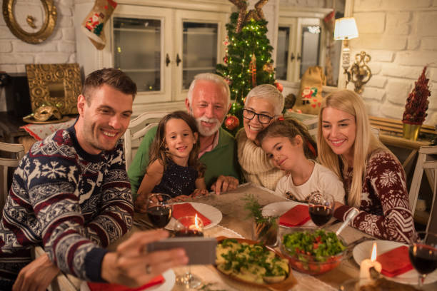 istock Family taking a selfie at Christmas dinner 1048333446