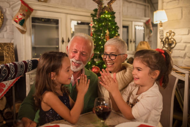 istock Old couple with playful grandchildren 1048335572