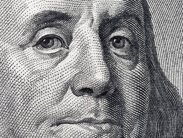 istock Closeup portrait Benjamin Franklin on 100 us dollar bill 1048336008