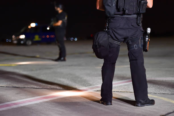 istock Night scene with special forces showing their skills in a simulated hostage rescue drill 1048336450