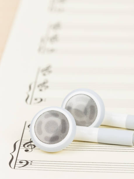 istock Earphone on  cream color paper music score 1048337004
