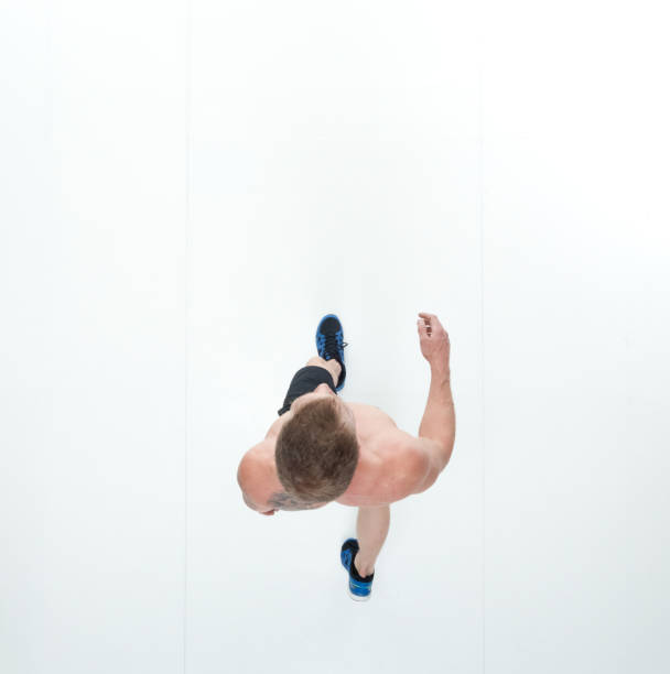istock Directly above view of shirtless man walking 1048344420